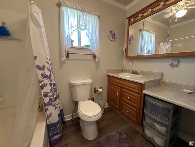 Full bath featuring ornamental molding, vanity, wood finished floors, and a ceiling fan | Image 17