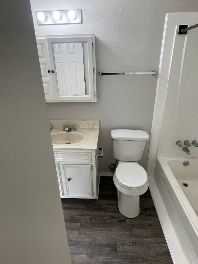 Full bathroom with vanity, wood finished floors, and shower combination | Image 10