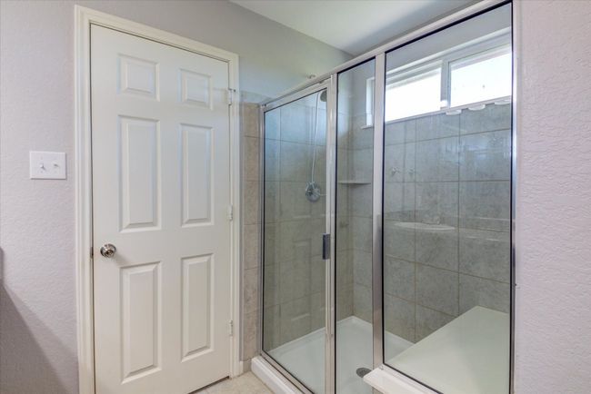 You will appreciate this oversized walk-in shower with a bench seat. | Image 25