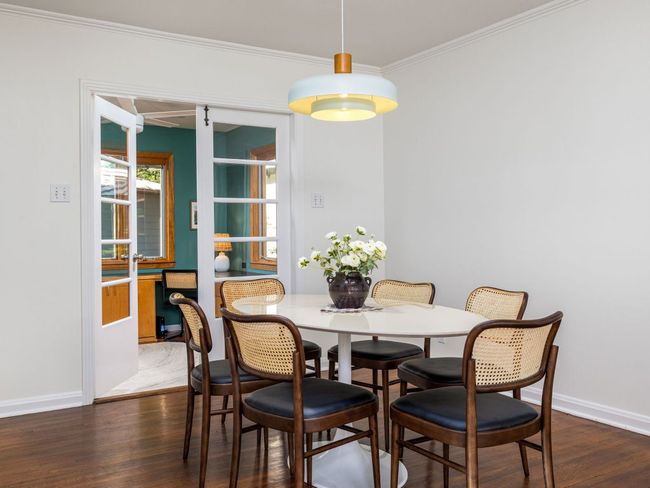 Dining room with wood flooring. | Image 7