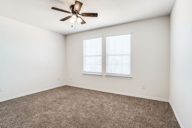 Carpeted spare room with a ceiling fan and baseboards | Image 10