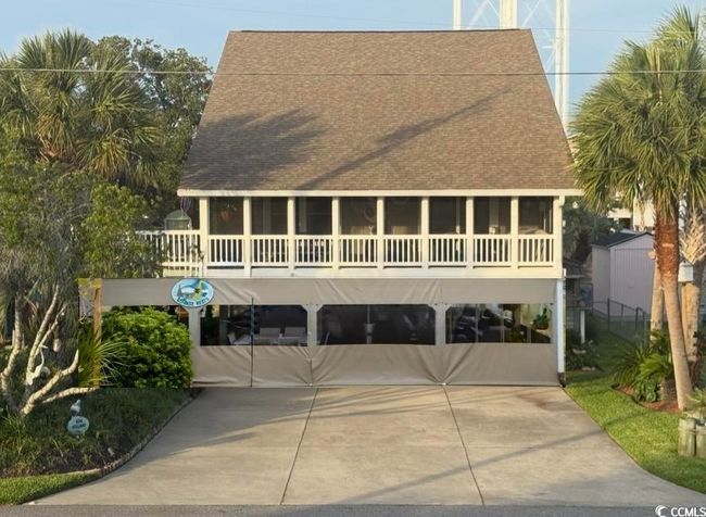 View of front of property featuring roof with shingles, a carport, and a sunroom | Image 4