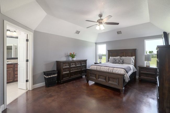 Trayed ceilings add depth to the space along with the two perfectly placed windows provide natural light while framing the room beautifully. | Image 17