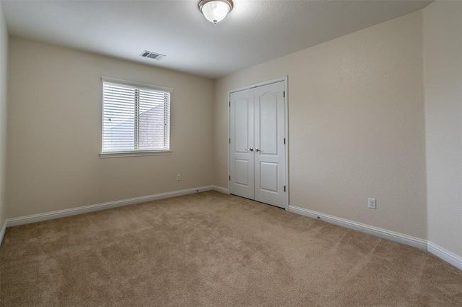 Unfurnished bedroom featuring light carpet and a closet | Image 12