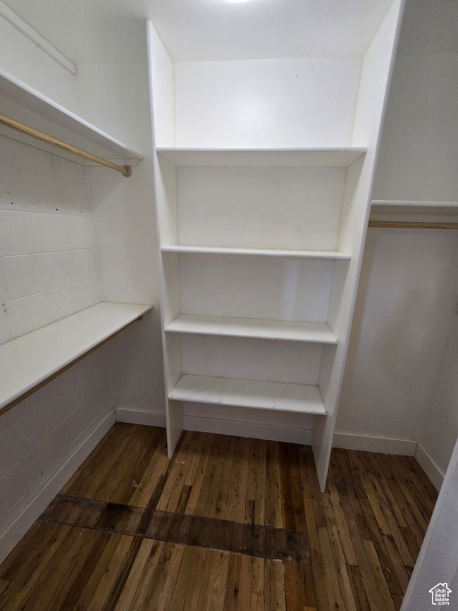 Walk in closet with wood finished floors | Image 10