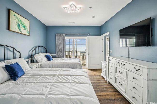 Bedroom with access to outside and dark wood-style floors | Image 25