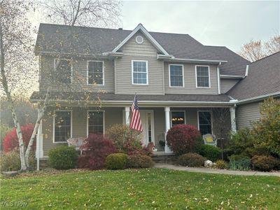 View of front of house featuring covered porch and a front yard | Image 1