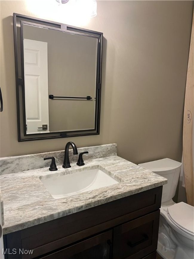 Half bathroom featuring toilet and vanity | Image 12