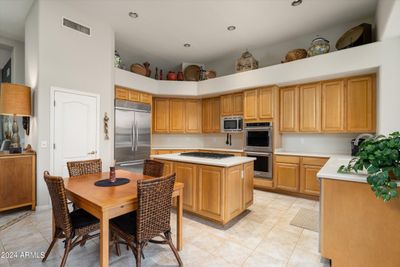 The kitchen opens to the family room and has newer KitchenAid stainless appliances and the desirable gas cooktop. | Image 3