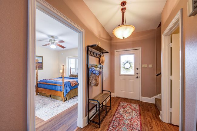Foyer entrance with healthy amount of natural light, wood finished floors, and a ceiling fan | Image 5