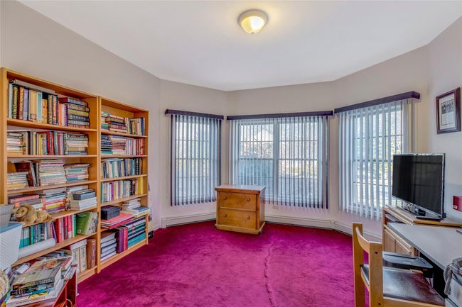 Sitting room featuring baseboard heating and carpet floors | Image 11