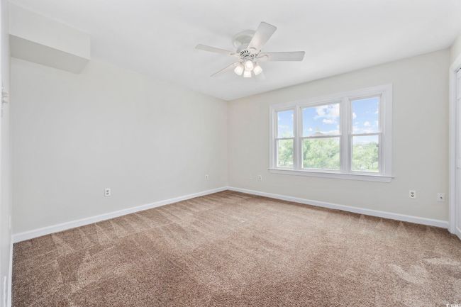Spare room with carpet flooring, baseboards, and ceiling fan | Image 27