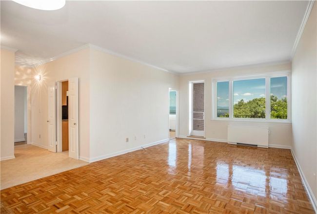Let's step inside unit 3L-1. You are immediately taken by the wall of windows in the Living Room. Zoom in to see the Hudson River in your backyard. Peeking into the Dining Room you will see even more! The large entry hall opens to the Living Room, Kitchen and Bedroom wing. Enjoy gleaming parquet floors in the freshly painted Living Room with door to private covered Balcony. | Image 4