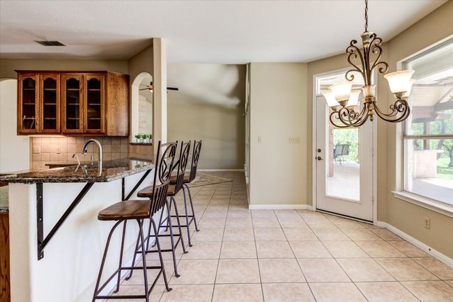 Views of and access to the pool and outdoor kitchen from the breakfast area make indoor/outdoor living seamless. | Image 9