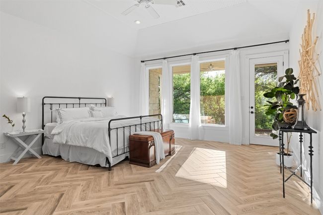 Bedroom with visible vents, baseboards, a high ceiling, ceiling fan, and access to outside | Image 14