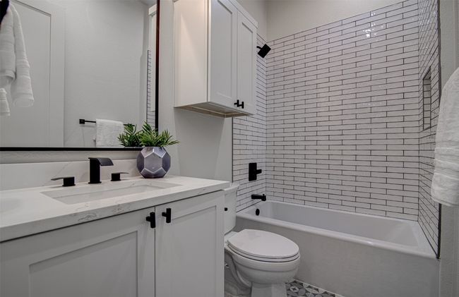 Bathroom featuring vanity, toilet, and tub / shower combination | Image 19