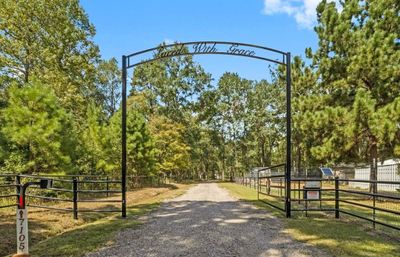 Iron gate entry and tree lined driveway to welcome you to 7105 Mount Zion Road. | Image 1