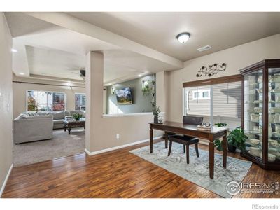 Venture to the basement to unwind in a captivating recreational room tastefully highlighted with wood paneling and stone veneer. | Image 2