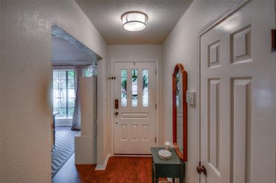 Foyer featuring a textured ceiling and dark hardwood / wood-style floors | Image 3