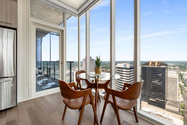 Your private balcony is accessible just off the kitchen and dining areas - the perfect spot to sip a beverage and take in the downtown views. | Image 12