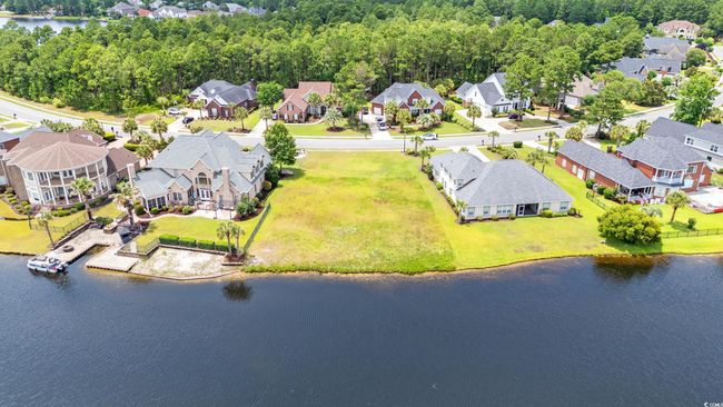 Aerial view of residential area featuring a nearby body of water | Image 7