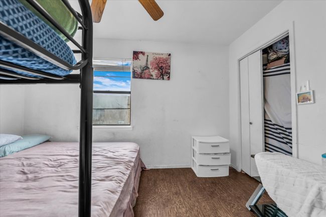 Bedroom featuring wood finished floors, a closet, and a ceiling fan | Image 14