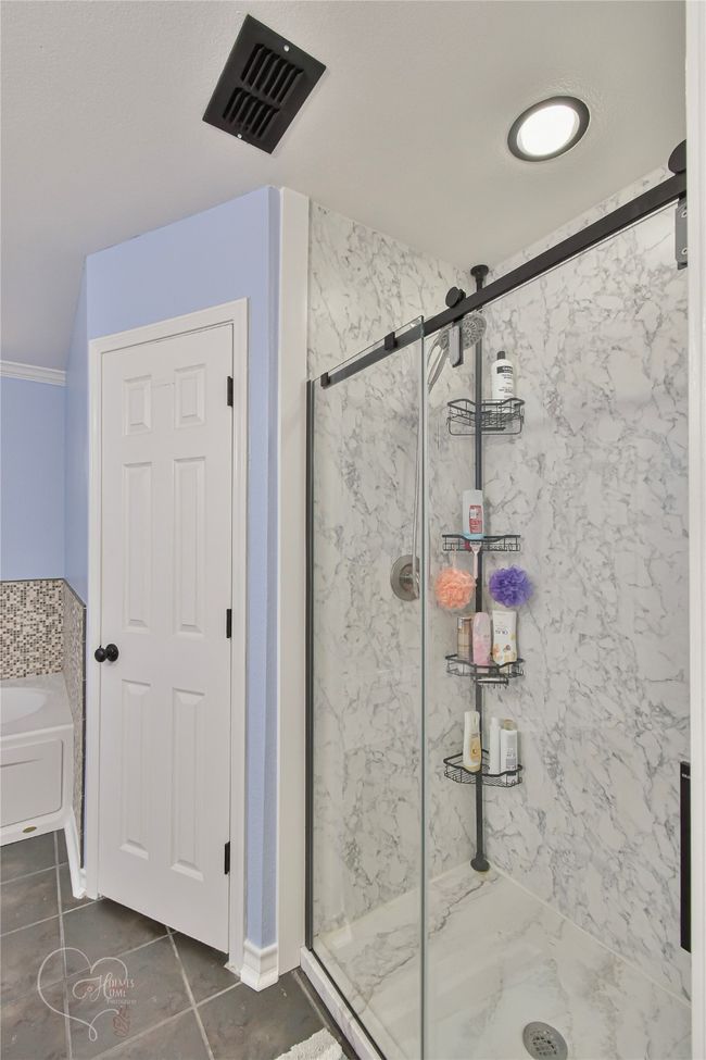 Full bathroom with a marble finish shower, a garden tub, and tile patterned floors | Image 28