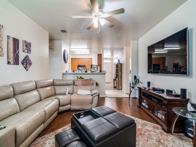 Living area featuring visible vents, a ceiling fan, and wood finished floors | Image 8