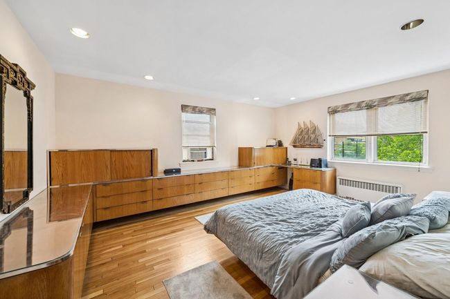 Bedroom with radiator, light wood-style floors, recessed lighting, and cooling unit | Image 12
