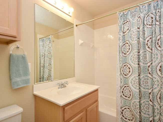 Full bathroom with toilet, vanity, and shower / bath combo with shower curtain | Image 17