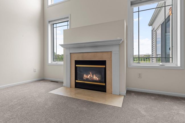 A gas fireplace with tile surround, and hearth also has a nice mantle. | Image 8