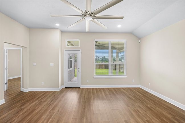 Spare room with a ceiling fan, wood finished floors, baseboards, and recessed lighting | Image 18