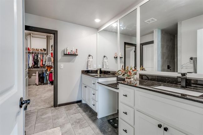 Full bath with a walk in closet, baseboards, vanity, and visible vents | Image 21