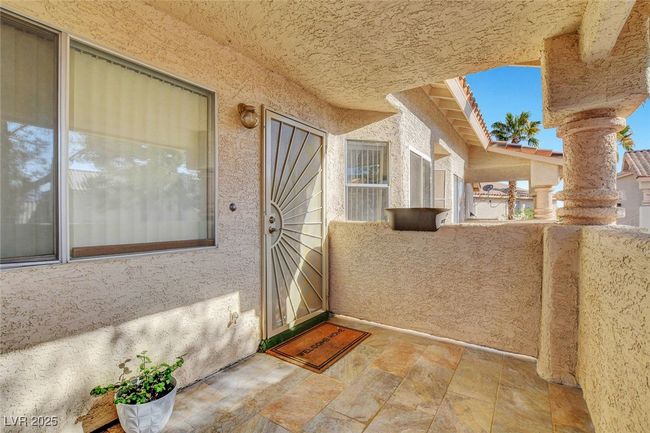 View of exterior entry with stucco siding and a balcony | Image 31