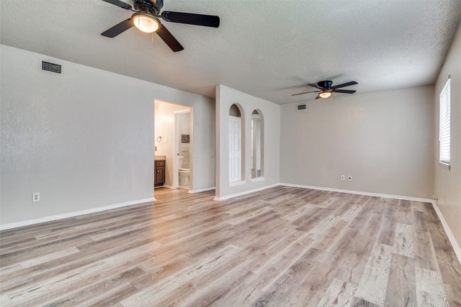 Unfurnished room with ceiling fan, a textured ceiling, and light wood-style floors | Image 20