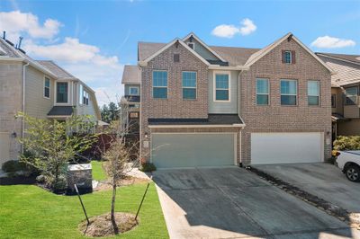 Welcome home! Beautiful 2 Story Chesmar Townhome in Woodridge Forest. This split-level design offers a spacious living area that is open to the breakfast room and Kitchen with Primary Room and utility conveniently located on the second floor. Two Secondary bedrooms, full bath and Flex/Gameroom downstairs. This gorgeous home features neutral color selections and a chef's kitchen equipped with quartz countertops, a large center island with stylish overhead pendant lighting and GE Stainless Steel Appliances. | Image 1