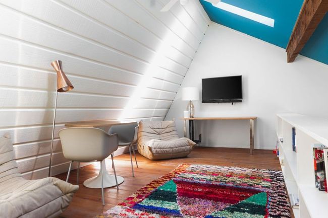 Living area with lofted ceiling with beams and wood finished floors | Image 11