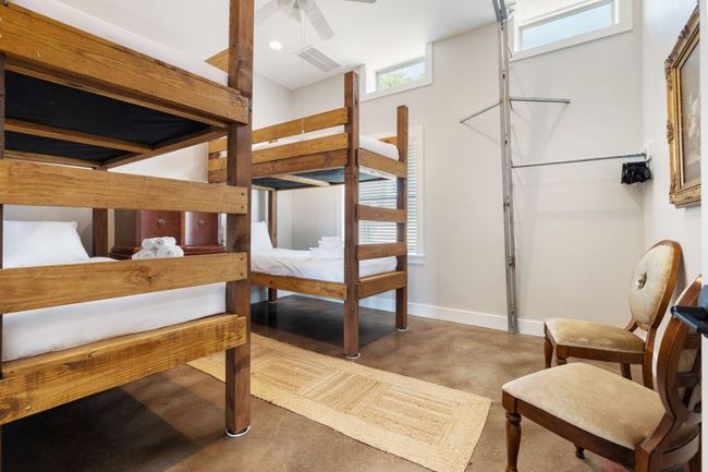Bedroom with finished concrete floors and baseboards | Image 10