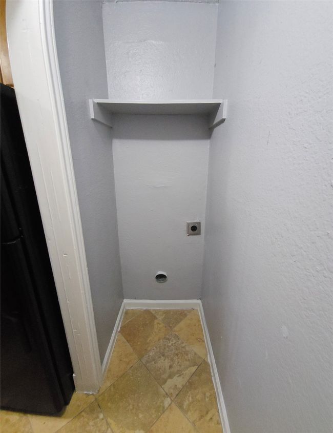 Laundry area with electric dryer hookup and stone finish flooring | Image 11