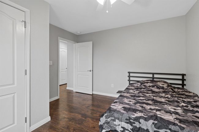 Bedroom featuring a ceiling fan, baseboards, and wood finished floors | Image 27