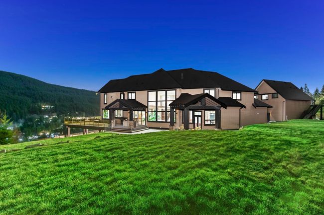 Back of house featuring a deck with mountain view, a lawn, and a gazebo | Image 40