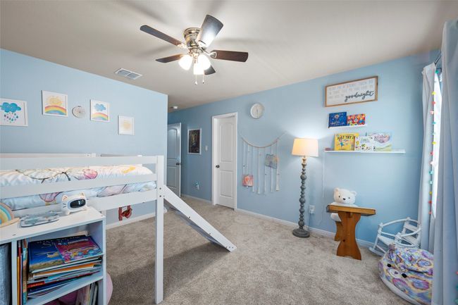 Carpeted bedroom with a ceiling fan and baseboards | Image 29
