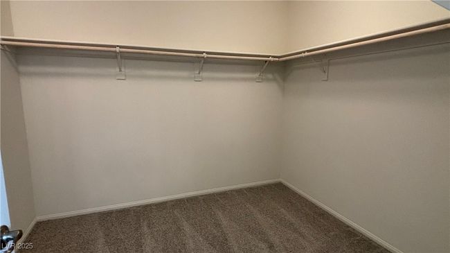 Spacious closet with dark colored carpet | Image 18