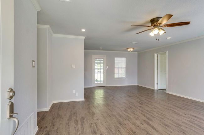 Unfurnished room with wood finished floors, ceiling fan, ornamental molding, and recessed lighting | Image 6