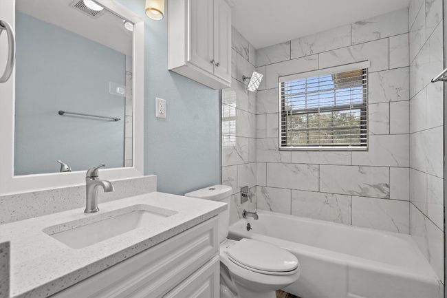 Full bath featuring vanity, shower / bathing tub combination, toilet, and visible vents | Image 27