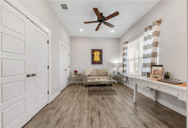 Living room with a ceiling fan, light wood-style floors, baseboards, and recessed lighting | Image 10
