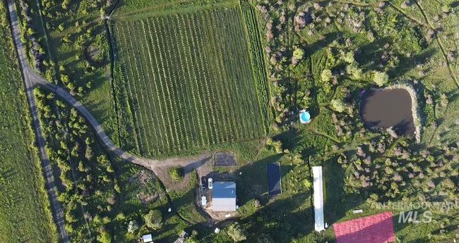 Aerial overview of property's location with rural landscape and large plots for crops | Image 44