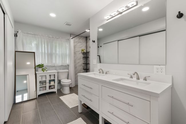 A much larger primary bathroom than is usually found in a house this age. | Image 27