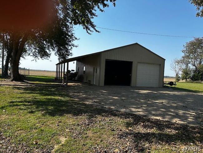 Garage featuring a yard | Image 18