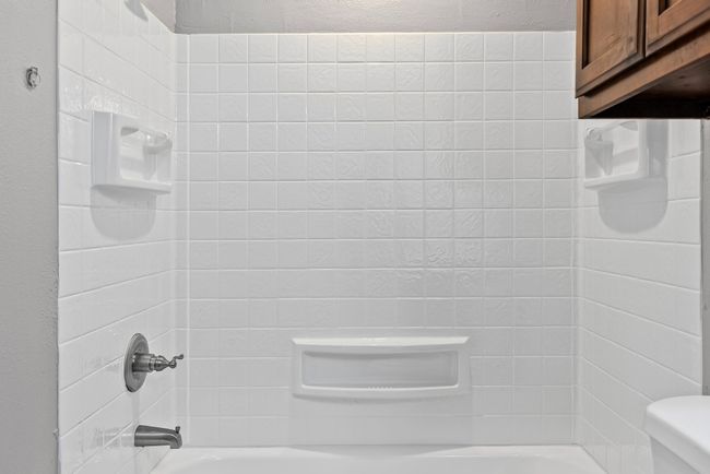 Bathroom featuring shower combination and toilet | Image 14
